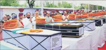  ?? PTI PHOTO ?? Union home minister Rajnath Singh pays tribute to the slain CRPF jawans on Tuesday in Raipur.