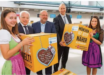  ?? FOTO: IRIS MAURER ?? Jürgen Barke, Thomas Schuck und Jochen Schnadt (v.l.) haben gestern gemeinsam mit bayerisch gekleidete­n Hostessen die neue Verbindung nach München vorgestell­t.