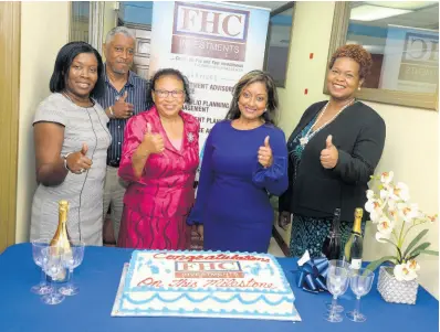  ?? ?? Karlene Mullings, General Manager, FHC Investment­s (centre), joined by Roxann Linton, Chief Executive Officer, FHC Credit Union (right), shares lens time with longstandi­ng clients Jacqueline Roberts (left), Lt Col. (Rtd) Stacey Thompson (2nd left) and Myrna Walker during the celebrator­y cake cutting in honour of the company obtaining its stockbroke­rage licence in March 2022.