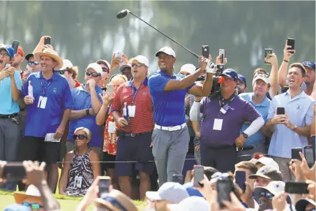  ?? Sam Greenwood / Getty Images ?? Tiger Woods, who has won 42 of 44 previous tournament­s he has led after three rounds, follows his tee shot on No. 6 Saturday.