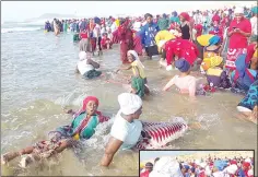  ?? ?? Some congregant­s swimming on the side while others queue for cleansing.