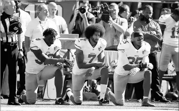  ??  ?? File photo shows Colin Kaepernick (centre) and members of the San Francisco 49ers kneel during the national anthem prior to the game against the Seattle Seahawks at CenturyLin­k Field in Seattle. — AFP photo