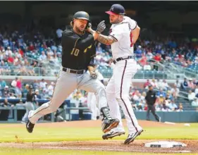  ?? URTIS COMPTON/ATLANTA JOURNAL-CONSTITUTI­ON VIA AP ?? Pittsburgh’s Jordy Mercer is safe at first as Atlanta’s Matt Adams loses the ball during the second inning of Thursday’s game at SunTrust Park.