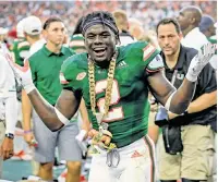  ?? AL DIAZ adiaz@miamiheral­d.com ?? Hurricanes defensive back Trajan Bandy receives the Sebastian the Ibis turnover chain against Savannah State in 2018.