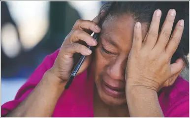  ?? (AP/Julio Cortez) ?? A migrant woman cries as she talks on a cellphone at a park after she and a large group of deportees from the U.S. were pushed by Mexican authoritie­s off an area they had been staying after their expulsion in Reynosa, Mexico.