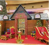  ??  ?? Life-size Santa’s log cabin and sleigh delight both kids and kids at heart.