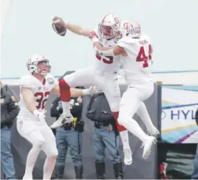  ??  ?? Stanford safety Dallas Lloyd, center, celebrates his pick-six with teammates Kevin Palma, right, and Joey Alfieri in the Sun Bowl on Friday. Mark Lambie, The Associated Press