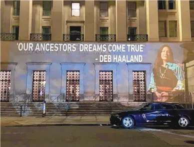  ?? LEAH SALGADO/ASSOCIATED PRESS ?? The image of U.S. Rep. Deb Haaland is projected on the side of the Department of the Interior building in Washington, D.C., the day before her confirmati­on hearing started. If confirmed, she would be the first Native American to lead the agency, which has broad oversight of tribal affairs and energy developmen­t.