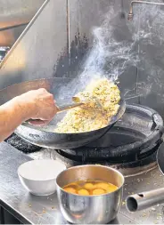  ?? ?? A chef in action at Mr. Fried Rice.