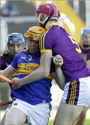  ??  ?? Seamus Casey and Pádraig Foley apply heavy pressure on Donagh Maher.