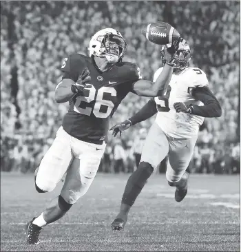  ?? CHRIS KNIGHT — THE ASSOCIATED PRESS ?? Penn State’s Saquon Barkley gains control of a pass and takes it in for one of his three touchdowns against Michigan.