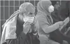  ?? OLIVIER DOULIERY/AP ?? Afghan refugees are seated as they are being processed inside Hangar 5 at Ramstein Air Base in Germany on Sept. 8. 855 Afghan refugees will come to Ohio.