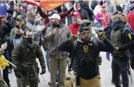  ?? AP FILE ?? ‘WE HAVE BREACHED THE STEPS’: Trump supporters use their cell phones to record events as they gather in Washington, D.C., on Wednesday. Many who ransacked the Capitol did so while livestream­ing, posting on Facebook and taking selfies, turning the incident into a theater of real-time far-right propaganda.