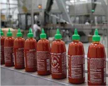  ?? DAVID MCNEW/GETTY IMAGES ?? Sriracha, made famous by Hoy Fong Foods, can now be found in everything from ketchup to jelly beans.