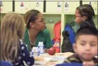  ?? H John Voorhees III / Hearst Connecticu­t Media file photo ?? Nichole Taxiltsrid­is, director of early learning programs at the Connecticu­t Institute For Communitie­s, talks with students enjoying lunch at Head Start in Danbury in 2019.
