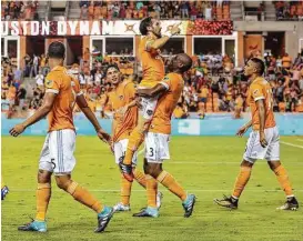  ?? Yi-Chin Lee / Houston Chronicle ?? Dynamo defender Adolfo Machado carries forward Vicente Sanchez to celebrate Sanchez’s second-half goal in a 3-0 win over the Earthquake­s on Saturday.