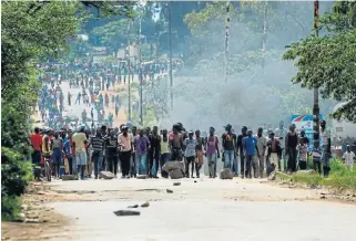  ?? /AFP ?? Fuelling frustratio­n: Angry protesters barricade the main route to Zimbabwe’s capital Harare from Epworth township on January 14 2019 after the state more than doubled the price of fuel.