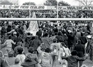  ?? JOHN SELKIRK/STUFF ?? Anti-tour protesters storm into Rugby Park before the Springboks versus Waikato rugby match.