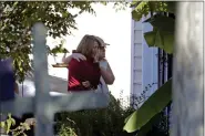  ?? CHRIS SEWARD — THE ASSOCIATED PRESS ?? Neighbors embrace as police remain on the scene at Castle Pines Dr. and Sahalee Way following a shooting Thursday night in Raleigh, N.C., on Friday.