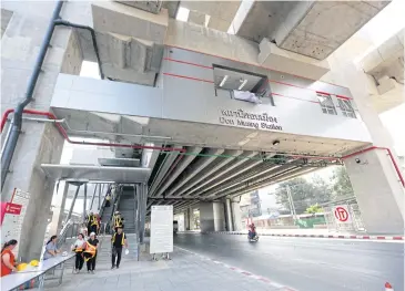  ??  ?? State Railway of Thailand staff walk down stairs at Don Mueang Station, which is part of the Red Line electric train project, which connects Bang Sue with the Rangsit area. The Red Line is set to be operationa­l by January 2021.