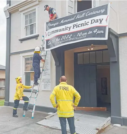  ?? Photo / Supplied ?? The banner being hung on the Pirongia Memorial Hall to advertise the upcoming celebratio­ns to commemorat­e its 100 years.