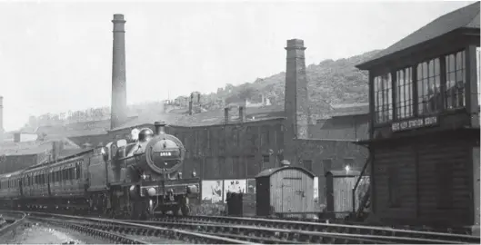  ??  ?? The tall boiler mountings identify No 1012 as a Midland-built Deeley engine as it runs towards Keighley Station South signal box with the driver having shut off steam to take the right-hand curve through the main line platforms with a down (northbound) service. The junction station is the main line connection for the Worth Valley branch to Oakworth, Haworth and Oxenhope. No 1012 ran as No 1007 from new in December 1905 until the MR renumberin­g scheme of 1907, was superheate­d in July 1921 and would serve until January 1951. Behind the Compound is one of the heavy industrial parts of Keighley that stretched from Thwaites and Marley Junction to the station and was dominated by textile, engineerin­g and foundry factories. Just in view on the far left, the line joining the up main serves the Keighley bay platform used by the frequent push-pull workings to and from Bradford (Forster Square) station.