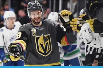  ??  ?? LAS VEGAS: Tomas Hyka #38 of the Vegas Golden Knights celebrates with teammates on the bench after he scored his first career NHL goal during the first period of a game against the Vancouver Canucks at T-Mobile Arena on February 23, 2018. — AFP