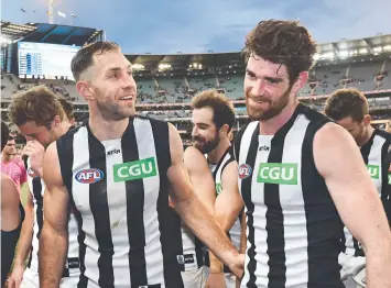 ?? Picture: AAP ?? Magpies Travis Cloke (left) with Tyson Goldsack after their match against Hawthorn.