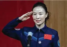 ?? Kevin Frayer / Getty Images ?? Like almost all other women, Col. Wang Yaping faces an undercurre­nt of sexism and condescens­ion in Chinese society.