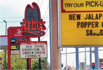  ?? JIM THOMPSON/JOURNAL ?? An Albuquerqu­e Arby’s displays a now-hiring message April 16 amid optimism about employment.
