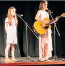  ??  ?? TESSA Higginson and Molly Pawson sang Butterfly Fly Away.