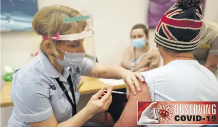  ?? (Photo: AFP) ?? NEWCASTLE UPON TYNE, United Kingdom — Key worker Mark Reid from North Shields receives the Pfizer-biontech Covid-19 vaccine at Life Science Centre, internatio­nal Centre for Life in Newcastle upon Tyne, north-east England, on January 9, 2021 — one of the seven mass vaccinatio­n centre, which will open to the public this week as Britain continues with their Covid-19 vaccinatio­n programme.