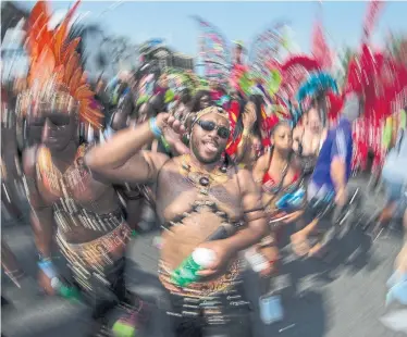  ?? RICK MADONIK/TORONTO STAR ?? The Caribbean Carnival Grande Parade Saturday is all about the costumes. The party started more than 50 years ago.