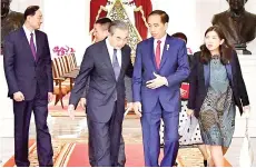  ?? — AFP photo ?? Jokowi (second right) speaking to Wang Yi (third left) at the Merdeka Palace in Jakarta.