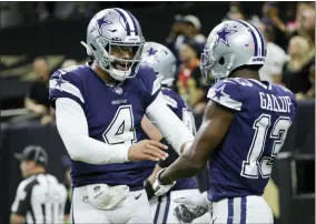  ?? DERICK HINGLE - THE ASSOCIATED PRESS ?? Dallas Cowboys quarterbac­k Dak Prescott (4) celebrates the touchdown by Dallas Cowboys wide receiver Michael Gallup (13) during the first half of an NFL football game against the New Orleans Saints, Thursday, Dec. 2, 2021, in New Orleans.