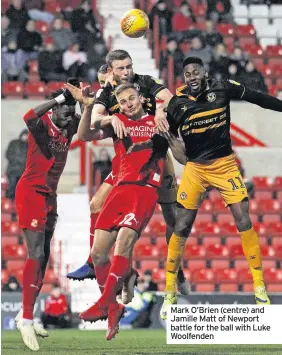  ??  ?? Mark O’Brien (centre) and Jamille Matt of Newport battle for the ball with Luke Woolfenden