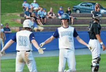  ?? THOMAS NASH - DIGITAL FIRST MEDIA ?? Daniel Boone’s Jeb Kurtz (35) celebrates with Matt Stevens (00) after the pair scored on Tim Richard’s dingle during the third inning.