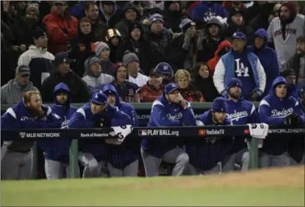  ?? AP PHOTO/DAVID J. PHILLIP ?? The Los Angeles Dodgers watch the ninth inning of Game 2 of the World Series baseball game from their dugout against the Boston Red Sox on Wednesday in Boston.