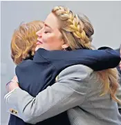  ?? ?? Amber Heard hugs Elaine Bredehoft, her attorney, who said the actress has ‘never pretended to be perfect’