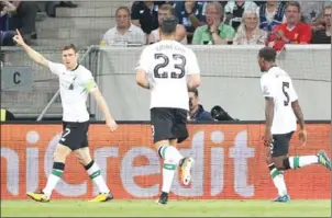  ?? DANIEL ROLAND/AFP ?? Liverpool’s James Milner (left) celebrates his side’s second goal in their Champions League qualifier against Hoffenheim on Tuesday night.