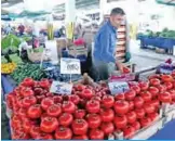  ?? — AFP ?? ANKARA: A seller prepares his stall at a market in the center of Ankara. Customers and shopkeeper­s say the diplomatic spat with Washington and the crash of the Turkish lira have strongly affected their daily lives.