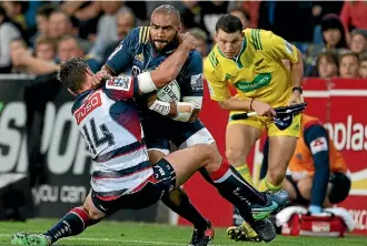  ?? PHOTO: GETTY IMAGES ?? Patrick Osborne tries to break the tackle of the Rebels’ Marika Koroibete last month.