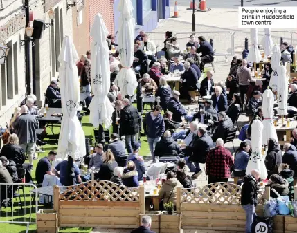  ??  ?? People enjoying a drink in Huddersfie­ld town centre