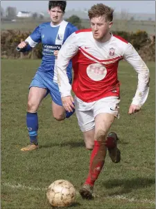  ??  ?? John Peare of Moyne Rangers is chased by Kevin Coleman of Tombrack.