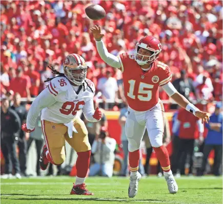  ?? JAY BIGGERSTAF­F/USA TODAY SPORTS ?? Chiefs quarterbac­k Patrick Mahomes, throwing before 49ers defensive tackle Sheldon Day could make a play, had 3 TD passes Sunday and now has a record 13 for the first three games in a season.