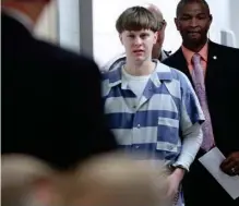  ?? (Grace Beahm/The Post And Courier via AP, File) ?? In this Monday, April 10, 2017, file photo, Dylann Roof enters the court room at the Charleston County Judicial Center to enter his guilty plea on murder charges in Charleston, S.C. Federal officials are for the first time showing videos of convicted...