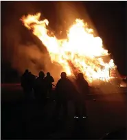  ??  ?? Firefighte­rs from the Amity and Monarch fire department­s are on hand as wood crates and other timber burn to provide a bonfire at Amity Township’s Harvest Festival.