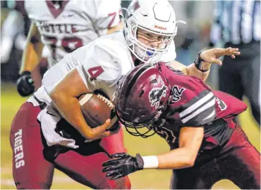  ?? [PHOTO BY NATE BILLINGS, THE OKLAHOMAN] ?? Tuttle’s Carson Berryhill carries the ball as Blanchard’s Ronnie Brown defends during Thursday’s game in Blanchard. Minco defeated Christian Heritage 40-34.