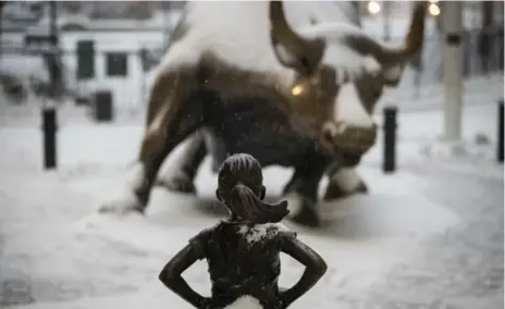  ?? DREW ANGERER/GETTY IMAGES FILE PHOTO ?? The Fearless Girl statue faces the famous Wall Street bull. A new study reveals how firms treat male and female employees differentl­y after misconduct.