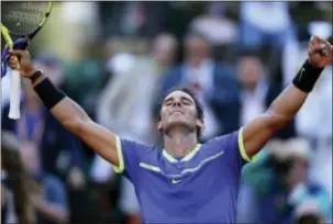  ?? DAVID VINCENT — THE ASSOCIATED PRESS ?? Spain’s Rafael Nadal raises his arms in victory after defeating Austria’s Dominic Thiem during their semifinal match of the French Open tennis tournament at the Roland Garros stadium Friday in Paris. Nadal won, 6-3, 6-4, 6-0.